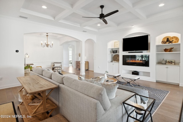 living room featuring built in shelves, light hardwood / wood-style flooring, and coffered ceiling