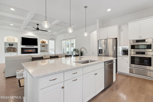 kitchen with coffered ceiling, a kitchen island with sink, sink, wood-type flooring, and white cabinetry