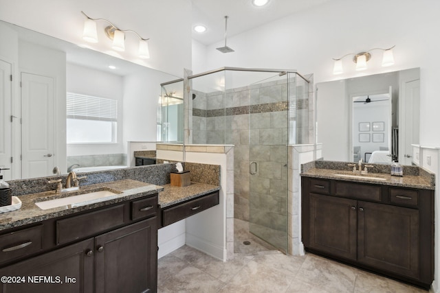 bathroom featuring tile patterned floors, ceiling fan, a shower with door, and vanity