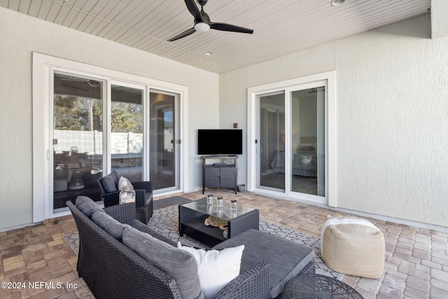 view of patio with an outdoor living space and ceiling fan