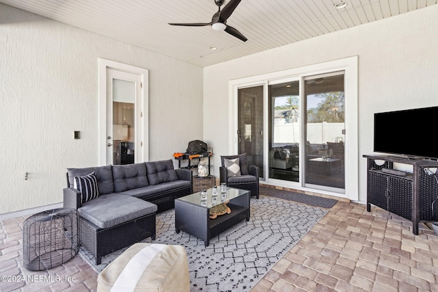 view of patio with an outdoor living space and ceiling fan