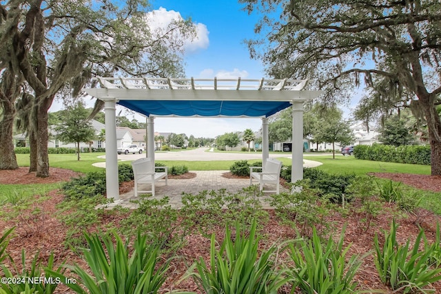 surrounding community featuring a pergola and a yard