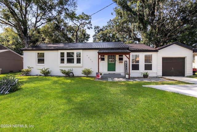 ranch-style home featuring a front yard and a garage