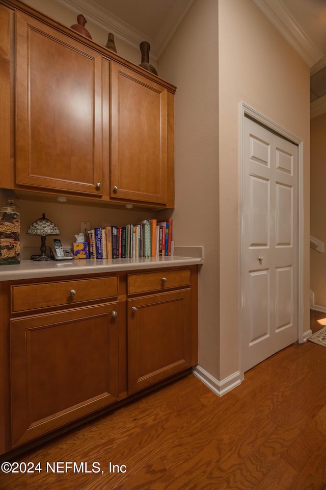 corridor featuring crown molding and light hardwood / wood-style flooring