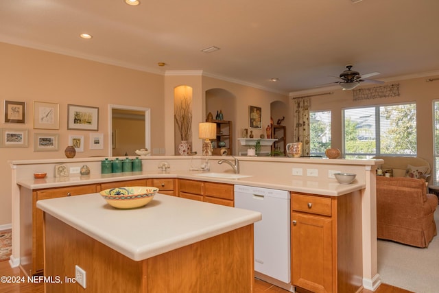 kitchen featuring ornamental molding, white dishwasher, ceiling fan, sink, and a kitchen island