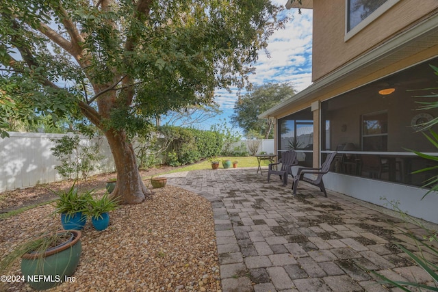 view of patio featuring a sunroom