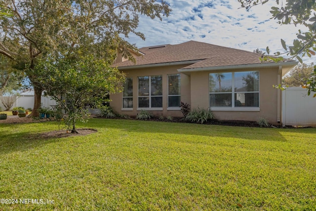 back of house with a yard