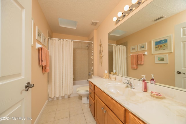 full bathroom featuring vanity, a textured ceiling, shower / bathtub combination with curtain, tile patterned flooring, and toilet