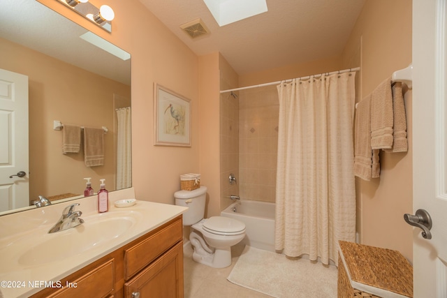 full bathroom with vanity, a skylight, tile patterned flooring, toilet, and shower / tub combo with curtain