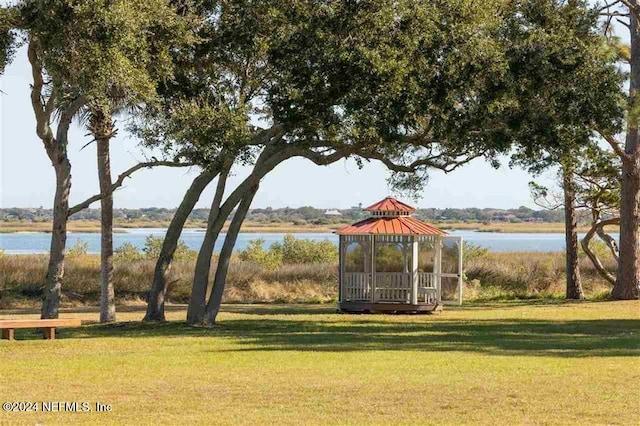 view of community with a gazebo, a water view, and a lawn