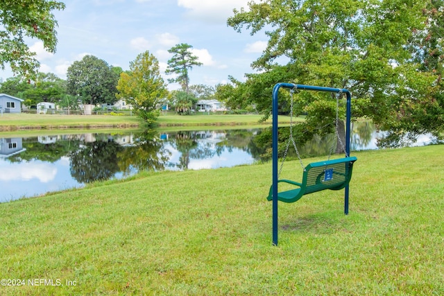 view of home's community featuring a yard and a water view