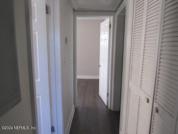 corridor with dark hardwood / wood-style floors