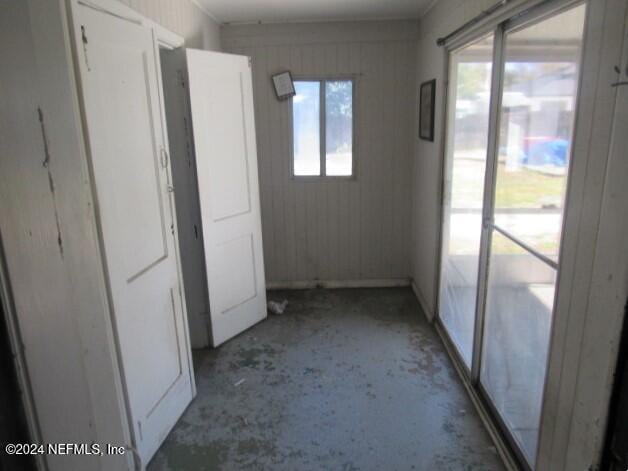 corridor featuring a healthy amount of sunlight and concrete flooring