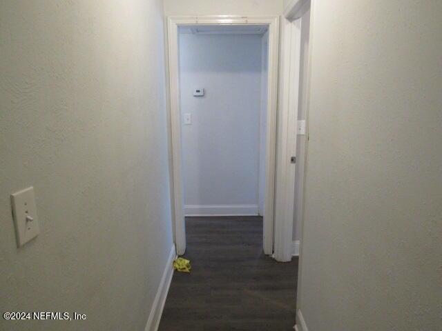 corridor with dark hardwood / wood-style floors