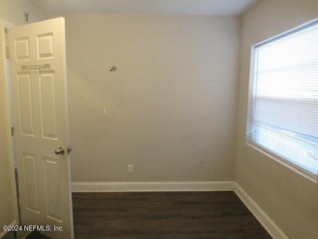 unfurnished room with dark hardwood / wood-style floors