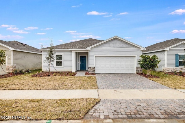 ranch-style home featuring a garage and a front yard