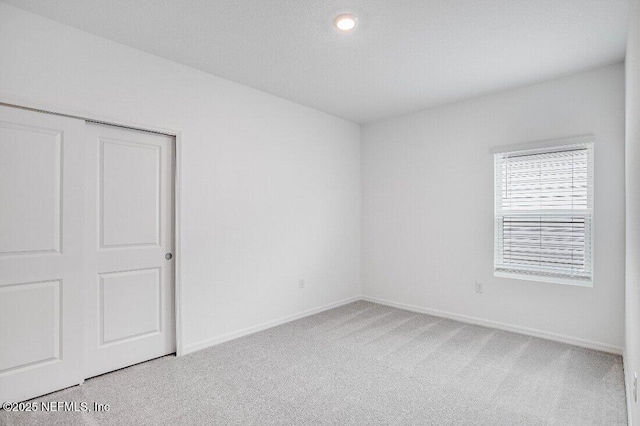 spare room with light carpet