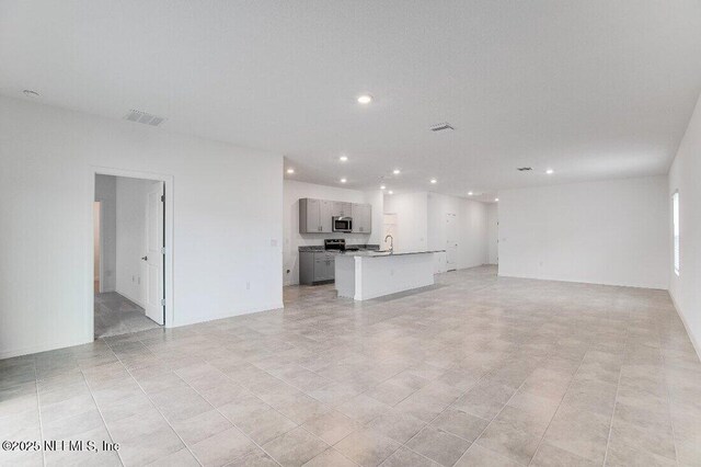 unfurnished living room featuring light tile patterned floors