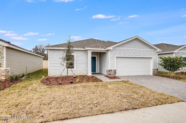 single story home with a garage and a front yard