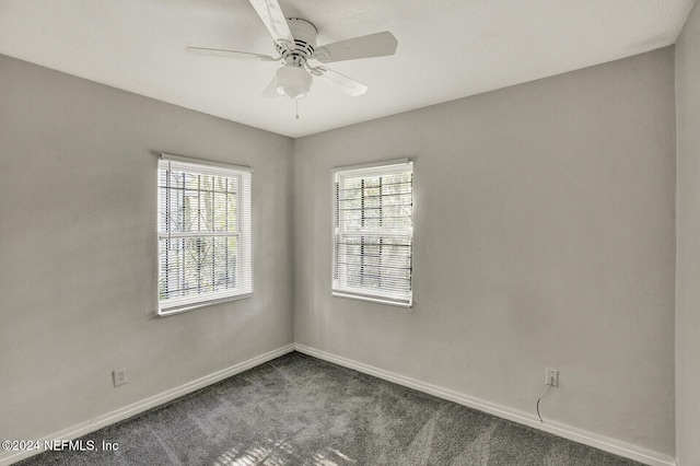 empty room featuring carpet flooring and ceiling fan