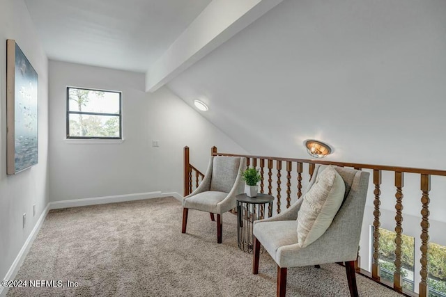 living area with carpet and lofted ceiling with beams