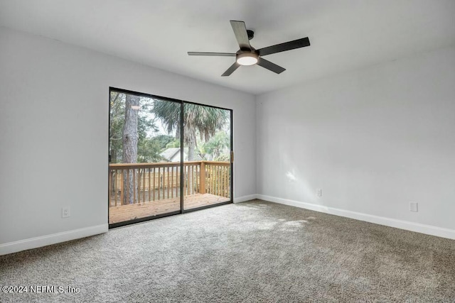 unfurnished room featuring ceiling fan and carpet