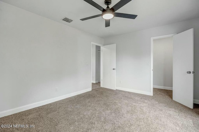 unfurnished bedroom with ceiling fan, carpet floors, and a closet