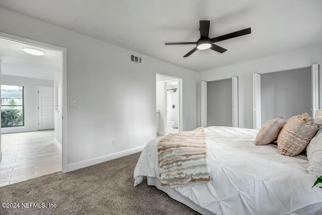 bedroom with carpet, ceiling fan, and ensuite bathroom