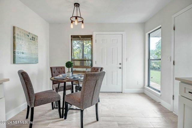 dining room with a wealth of natural light and an inviting chandelier