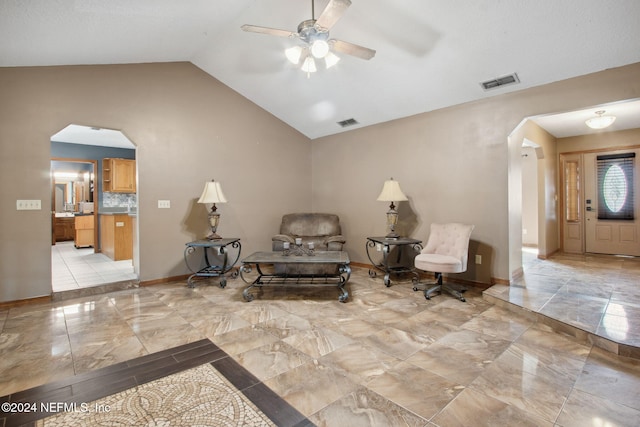 living area featuring vaulted ceiling and ceiling fan