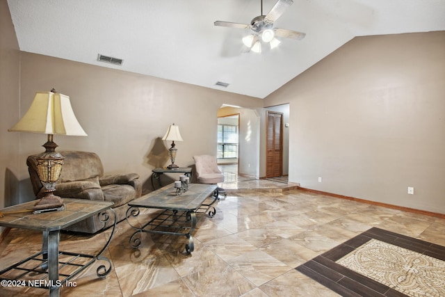 living room featuring ceiling fan and lofted ceiling