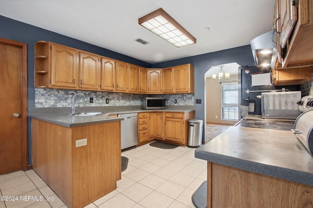 kitchen featuring sink, light tile patterned floors, stainless steel appliances, and a chandelier