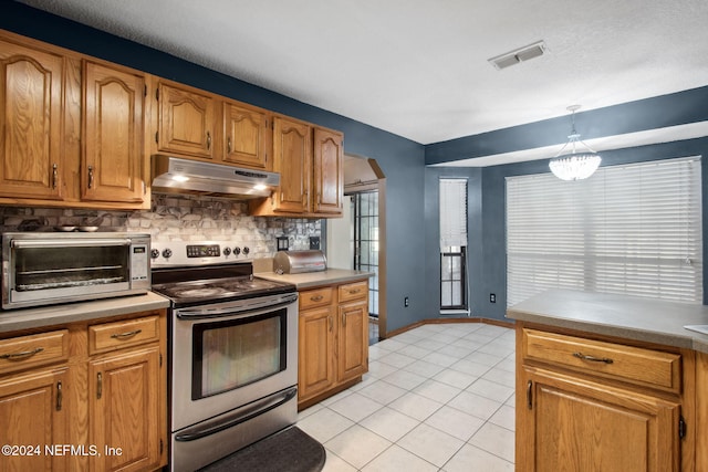 kitchen featuring tasteful backsplash, hanging light fixtures, stainless steel range with electric cooktop, and light tile patterned flooring