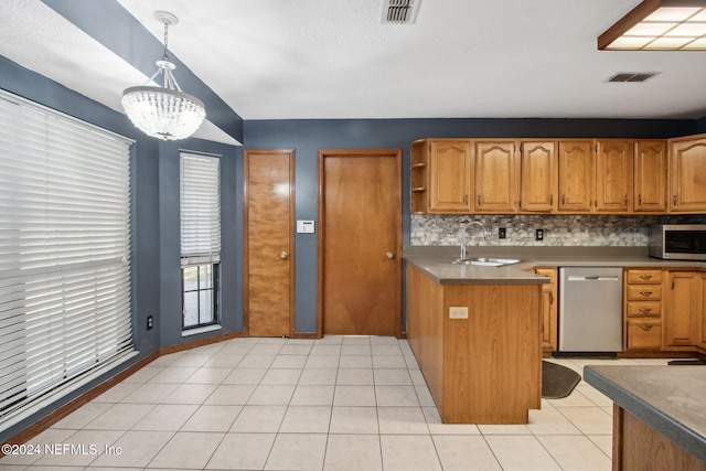 kitchen featuring appliances with stainless steel finishes, sink, pendant lighting, light tile patterned floors, and a notable chandelier