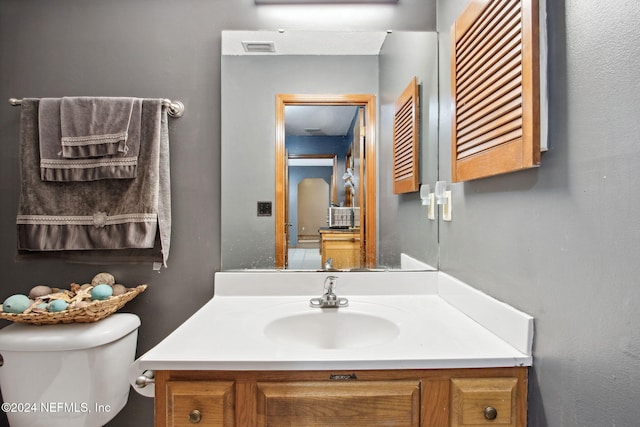 bathroom featuring vanity and toilet