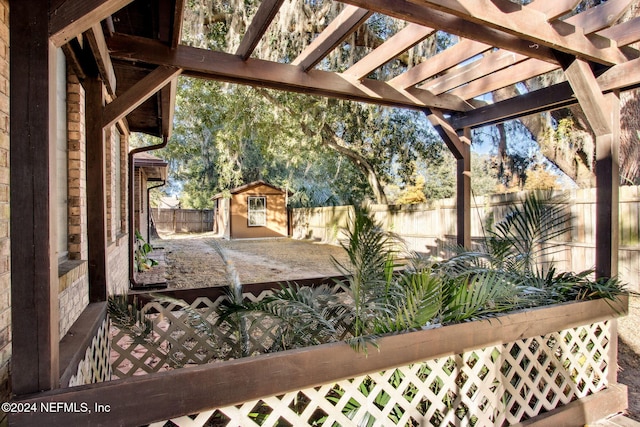 exterior space with a pergola and a storage shed