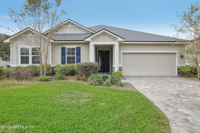 view of front of house with a front yard and a garage