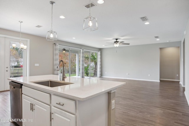 kitchen featuring white cabinetry, hanging light fixtures, stainless steel dishwasher, sink, and a center island with sink