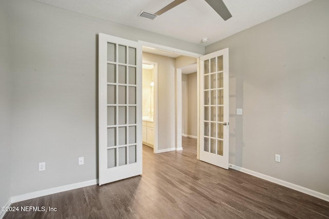 unfurnished room featuring ceiling fan, french doors, and dark wood-type flooring