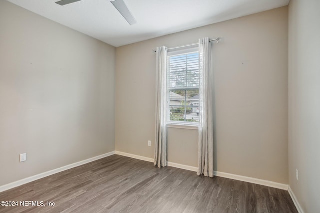 empty room featuring hardwood / wood-style flooring and ceiling fan