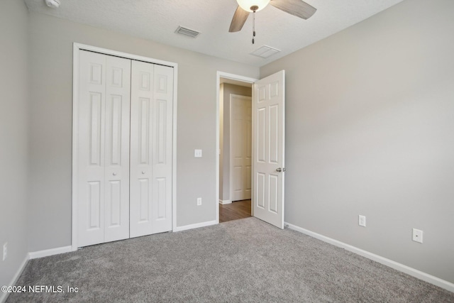 unfurnished bedroom featuring carpet, a closet, and ceiling fan