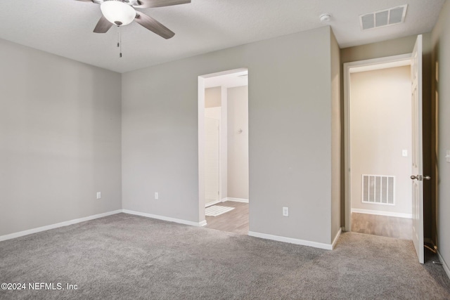 unfurnished bedroom featuring light carpet and ceiling fan