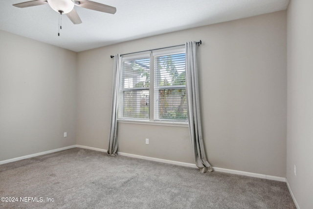 empty room with light colored carpet and ceiling fan