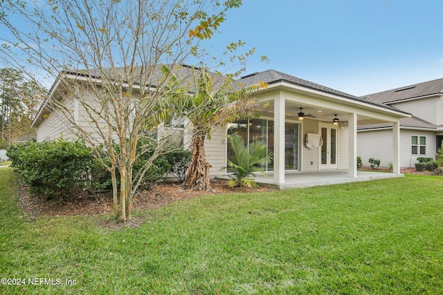 back of house featuring a patio area, a lawn, and ceiling fan