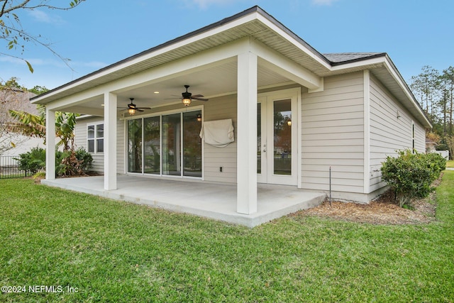 rear view of house featuring a lawn, ceiling fan, and a patio