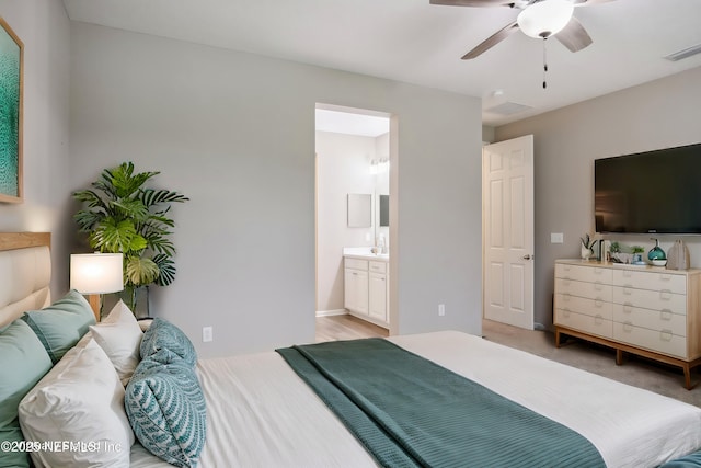 carpeted bedroom with ceiling fan and connected bathroom