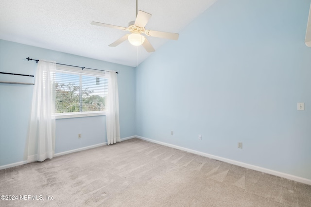 carpeted empty room featuring a textured ceiling, ceiling fan, a wall mounted air conditioner, and vaulted ceiling