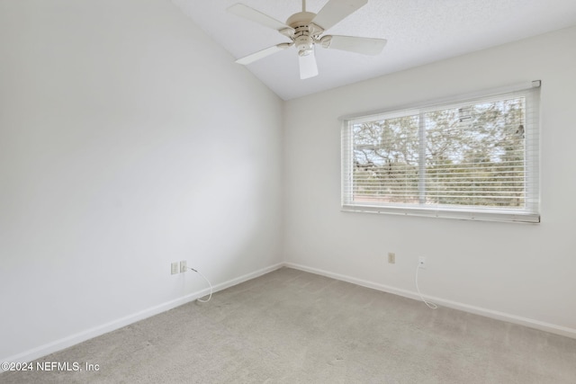 carpeted empty room with ceiling fan and lofted ceiling