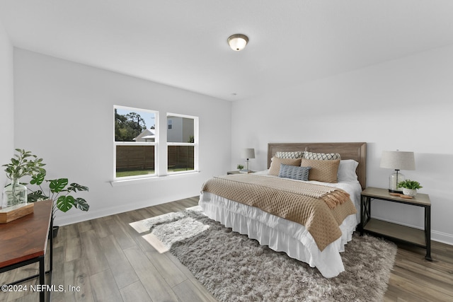 bedroom with hardwood / wood-style flooring