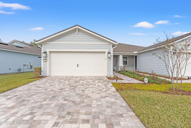 single story home with a garage and a front lawn